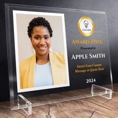 a clear acrylic award plaque with an image of a smiling woman on it