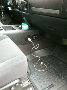 the interior of a car with an electronic device plugged in