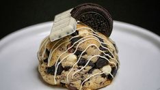 an oreo cookie with white chocolate drizzles and cookies on the top