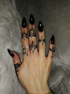 a woman's hand with tattoos on it