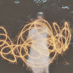 a blurry image of a person holding firework