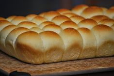 a loaf of bread sitting on top of a wooden cutting board