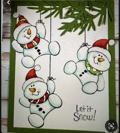 two snowmen hanging from a tree with the words let it snow written on them