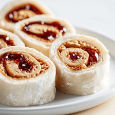 several rolls on a plate with jelly filling