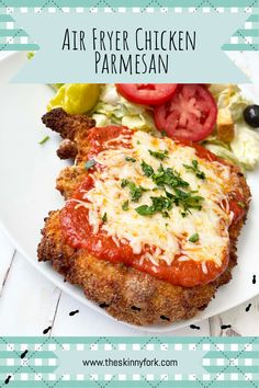 an air fryer chicken parmesan on a plate with tomatoes and lettuce