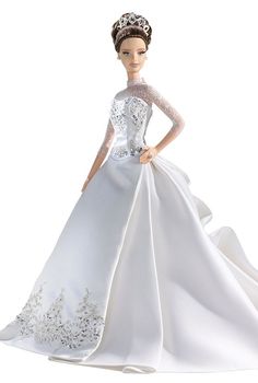 a barbie doll wearing a white dress and tiara, standing in front of a white background