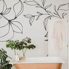 a bath tub sitting next to a green plant