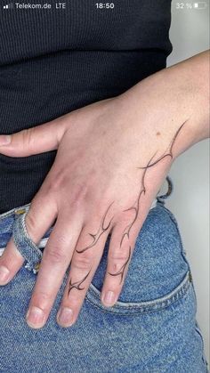 a woman's hand with a tattoo on it