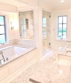 a large bathroom with two sinks and a bathtub in the middle of the room