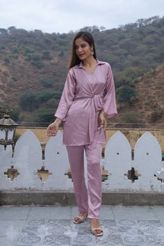 Description :- Fabric. - satin silk  Color - Dusky pink  Neck line - V- neckline with collar  Contain - Top and Trouser. Made from lightweight breathable fabric. sizes available UK/ US - 8 , 10, 12, 14, 16, 18  Introducing our "In Full Bloom " co-Ord set, made from luxurious satin silk fabric in a lovely Dusky Pink hue. This stylish set features a V-neckline with a collar, adding an elegant touch to your look. The set includes a charming top and comfortable trousers. Get ready to elevate your st Silk V-neck Party Sets, Elegant Pink Pant Set For Party, Feminine Pink V-neck Set, Elegant Satin V-neck Sets, Elegant V-neck Sets For Wedding Night, Pink Matching Palazzo Set, Pink Feminine V-neck Set, Pink Satin Sets For Wedding Night, Pink V-neck Wedding Sets