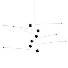 a group of black balls are connected to one another by wires and red dots in the middle