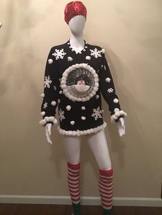 a mannequin dressed in black and white clothing with snowflakes on it