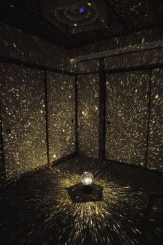 a room filled with lots of lights and stars on the wall next to each other