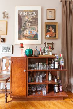 an old fashioned liquor cabinet filled with bottles and glasses