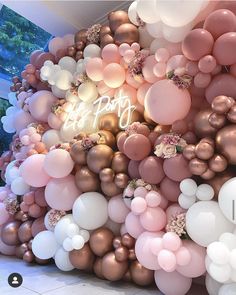 the balloon wall is filled with pink, white and gold balloons