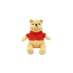 a teddy bear with a red shirt on sitting in front of a white background and looking at the camera