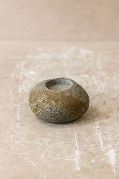 a rock sitting on top of a white floor