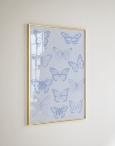 a blue butterfly print hangs on the wall