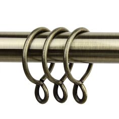 three metal rings hang from the side of a curtain rod with two loops on each end