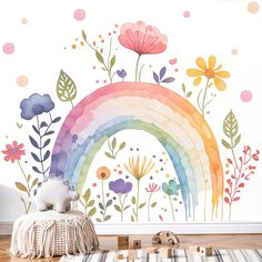 a child's room with a rainbow wallpaper and flowers on the wall behind it