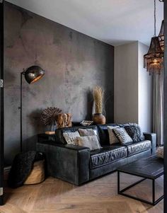 the living room is decorated in black and grey tones with wood flooring, chandelier