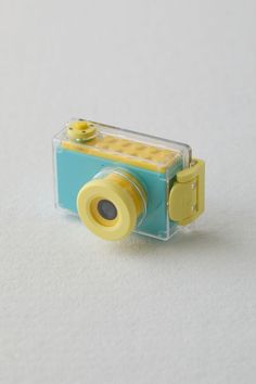 a yellow and blue camera sitting on top of a white table