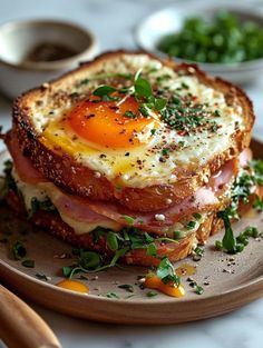 an egg and bacon sandwich is on a plate