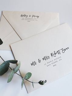 two wedding envelopes with the words mr and mrs written on them