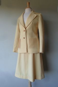 "1970s Lilli Ann Suit with classic 1970s details * Beautiful contrasting top stitching in brown at cuffs, collar, pockets and waist band * Fully lined skirt and jacket * Tucked front pockets * Two button front closure on jacket with button and zipper closure on skirt * Band at top of vent in back on jacket * Skirt, simple 4 gores into an A-line * Shown on 37-27-37 dress form ---------- Measurements are in inches and are approximate: ---------- Jacket ---------- Bust: 36-38 Waist: 30-32 Sleeve le Classic Spring Skirt Suit With Pockets, Retro Fitted Skirt Suit, Retro Long Sleeve Skirt Suit For Tailoring, Lilli Ann, Spring Yellow, Skirt And Jacket, Womens Suits, Vintage Suits, Skirt Fits