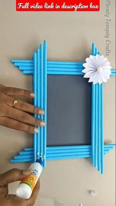 someone is painting the frame with blue paint