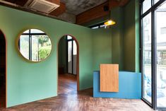 an empty room with round windows and wooden floors