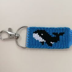 a knitted key chain with an orca whale on it