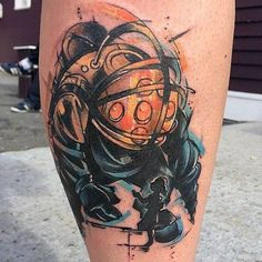 a tattoo on the leg of a person with an orange and black helmet in it