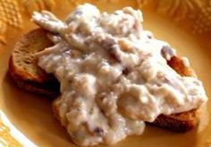 a plate topped with two pieces of bread covered in gravy