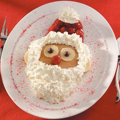 a white plate topped with a face covered in whipped cream