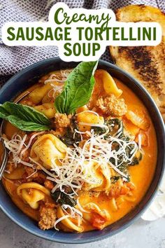 creamy sausage tortellini soup in a blue bowl with parmesan bread on the side