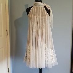 a white dress on a mannequin in front of a blue wall and door