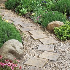 a garden with rocks and flowers in it