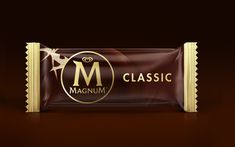 a chocolate bar with the word'm'in gold lettering on it, sitting on a brown background