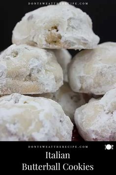 a pile of powdered sugar cookies sitting on top of a red plate