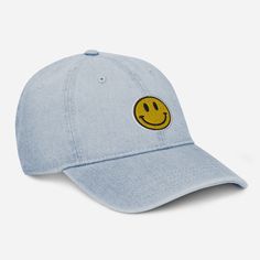 a blue hat with a smiley face embroidered on the front