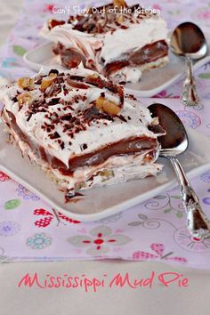 two pieces of dessert sitting on plates with spoons