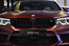 the front end of a brown bmw m5