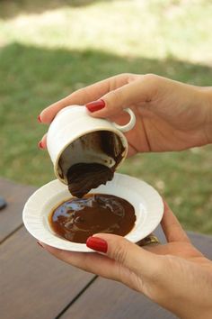 a woman is pouring chocolate into a paper plate