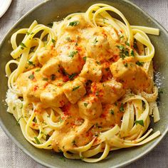 a plate of pasta with chicken and sauce