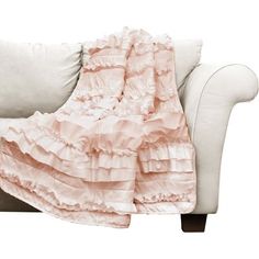 a white couch with a pink ruffled blanket on it