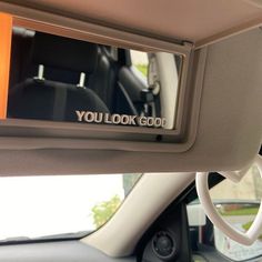 you look good written on the side mirror of a car's dash board and steering wheel