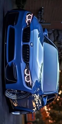 the front end of a blue sports car