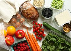 various fruits and vegetables are laid out on a table