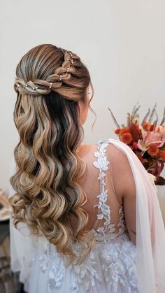 the back of a woman's head with long wavy hair, wearing a veil